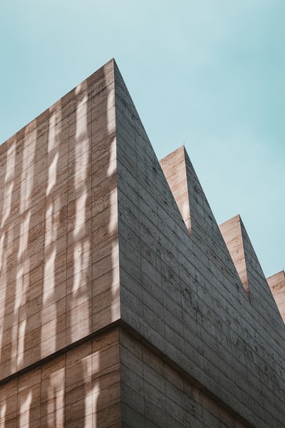 Brown concrete building under the blue sky during the day
